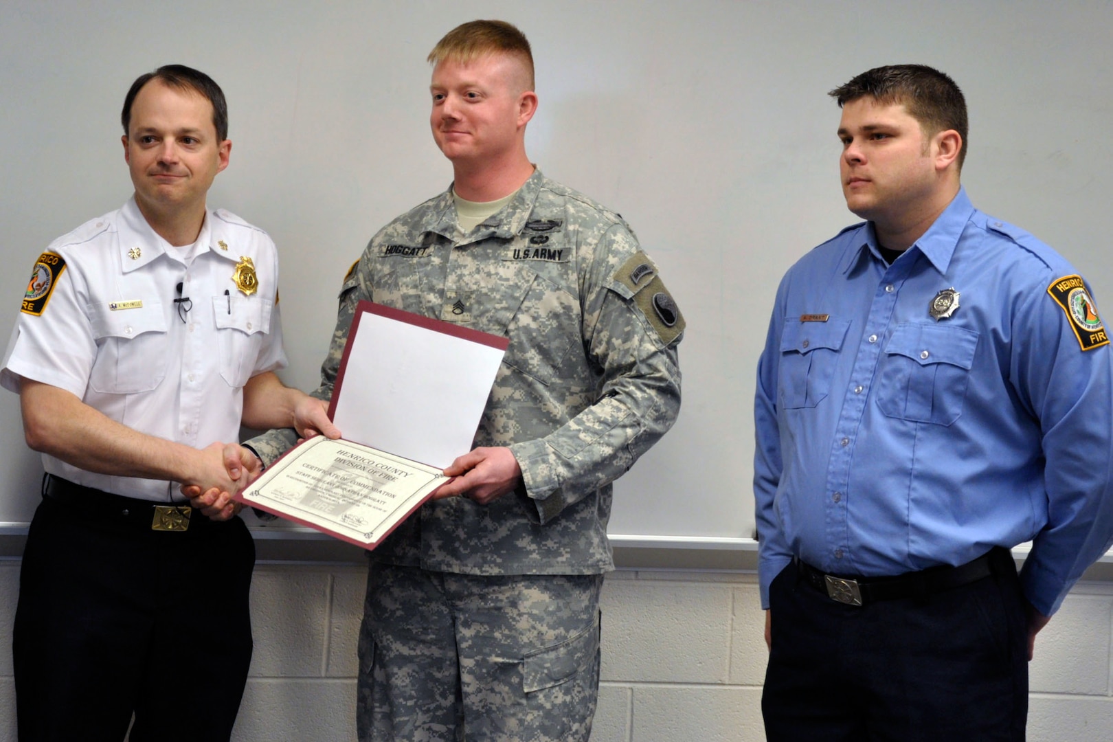 Henrico County Division of Fire Chief Anthony E. McDowell presents a certificate of commendation to Staff Sgt. Johnathan Hoggatt of the Virginia National Guard March 11, 2014