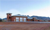Fort Huachuca Fire Station No. 2, a $6.8 million complex completed in May 2012, is a 16,000 square-foot, two-company fire station with a hose drying tower, wash rack, flammable storage, three drive-through parking stalls and individual dorm rooms to house up to 12 firefighters. The fire station design includes efficiencies such as LED lighting, a water recirculation system used to wash the fire trucks, solar panels to generate power to heat water, and a lighting system that automatically turns off lights in vacant rooms and offices. The hose drying tower on the east side of the building  allows fire crews to properly hang and dry fire hoses in lieu of the old method of laying them on the ground. The project was built to LEED Silver Standards and has the potential to reach LEED Gold Standard.