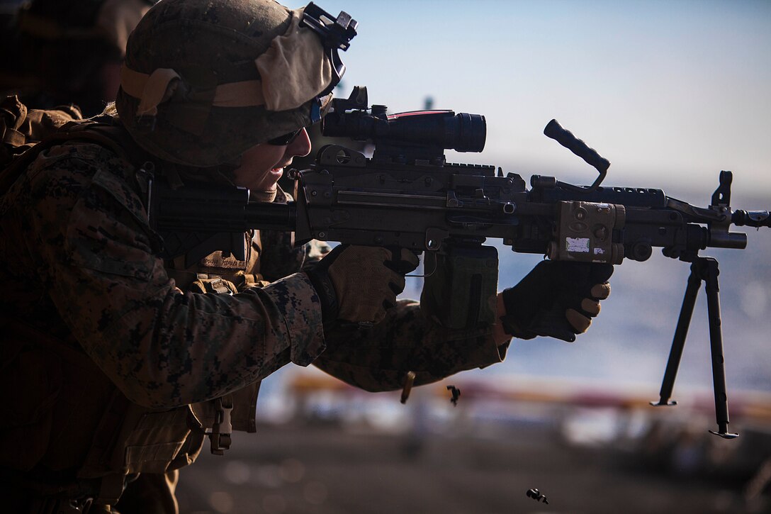 A U.S. Marine with Battalion Landing Team 1st Battalion, 6th Marine Regiment, 22nd Marine Expeditionary Unit (MEU), fires an M249 squad automatic weapon during a live-fire range aboard the USS Bataan (LHD 5), at sea, March 4, 2014. The MEU is deployed to the U.S. 6th Fleet area of responsibility with the Bataan Amphibious Ready Group as a sea-based, expeditionary crisis response force capable of conducting amphibious missions across the full range of military operations. (U.S. Marine Corps photo by Sgt. Austin Hazard/Released)