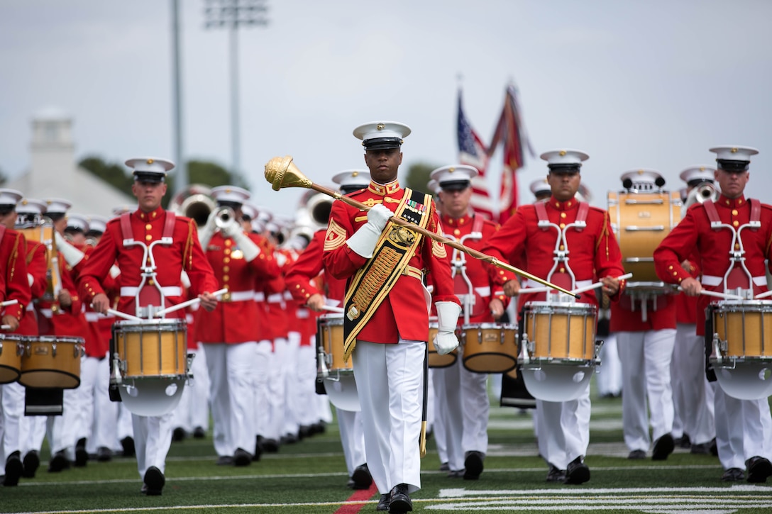 The Drum and Bugle Corps, led by Master Gunnery Sgt. Kevin D. Buckles, perform a pass and review at the Paige Fieldhouse during a 2014 Battle Color Detachment drill exhibition March 13. Commonly referred to as The Commandant's Own, the Drum and Bugle Corps performed choreographed marching routines. The Drum and Bugle Corps’ are easily distinguished by their scarlet dress uniform coats and white trousers. Buckles is the drum major for the Marine Corps Drum and Bugle Corps.