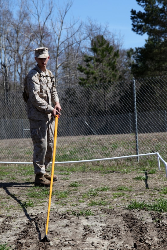 Lance Cpl. Creston Wood practices techniques for marking the exact placement of an improvised explosive device at Marine Corps Base Camp Lejeune, March 11. Marine Wing Support Squadron 271 conducted squadron training March 3-12, focusing on strategies and techniques for countering IED attacks. Wood is a combat engineer with MWSS-271. 