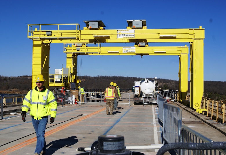 The Gantry crane shown here had to be custom built to fit the width of the roadway to remove the old roadbed sections and structural items. It will also be used to replace the 36x40 foot bridge spans with seven prefabricated 6x36 foot panel sections. The deck slab panels were built off site.                  