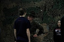 Sgt. Jamie L. Murray, a drill instructor for Platoon 4013, Company P, 4th Recruit Training Battalion, Marine Corps Recruit Depot Parris Island, gives a poolee her first taste of what to expect when she arrives for Marine Corps recruit training during Recruiting Station Kansas City's all-hands female pool function at Building 712 at the 9th Marine Corps Recruit District Headquarters March 15, 2014. The poolees were instructed on close-order drill, what to expect during recruit training, and hygiene.