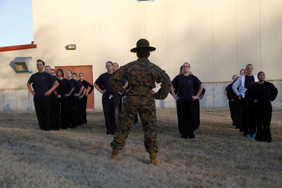 Sgt. Britni M. Garcia Green, a Platoon 4017, Company N, 4th Recruit Training Battaltion, Marine Corps Recruit Depot Parris Island drill instructor, leads female poolees during warm-up stretches during Recruiting Station Kansas City's all-female pool function at 9th Marine Corps District's Building 712 March 15, 2014. The poolees were instructed on close-order drill, what to expect during recruit training, and hygiene. Poolees from all the Recruiting Sub-Stations in the RS were on-hand for the event.