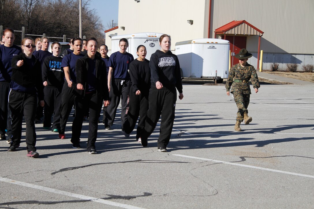 Sgt. Britni M. Garcia Green, a Platoon 4017, Company N, 4th Battaltion, Marine Corps Recruit Depot Parris Island drill instructor, teaches poolees the basics of marching and drilling during Recruiting Station Kansas City's all-female pool function outside 9th Marine Corps District's Building 712 March 15, 2014. The poolees were instructed on close-order drill, what to expect during recruit training, and hygiene and also performed a mock Inital Strength Test with consisted of the flexed-arm hang, crunches and 1.5-mile run. Poolees from all the Recruiting Sub-Stations in the RS were on-hand for the event.