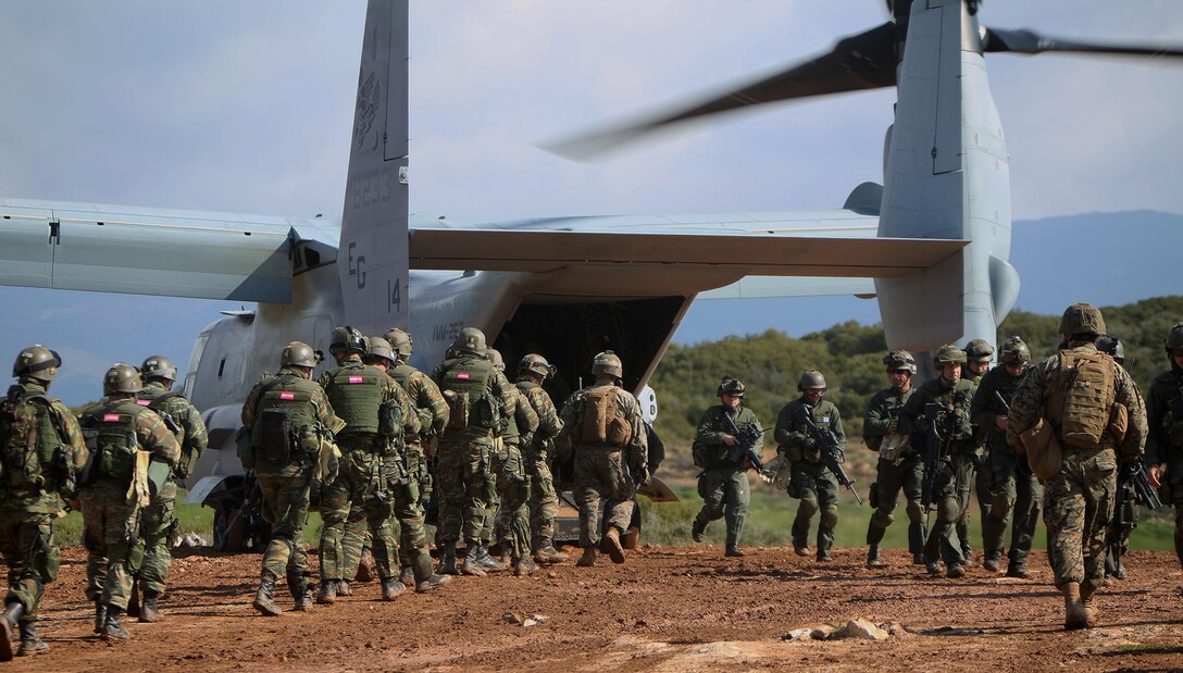 U.S. Marines with Battalion Landing Team 1st Battalion, 6th Marine Regiment, 22nd Marine Expeditionary Unit (MEU), and members of the Hellenic Army board and exit an MV-22 Osprey aircraft during a bilateral training exercise. The U.S. and Greece regularly conduct scheduled military exercises to strengthen professional and personal relationships. The MEU is deployed to the U.S. 6th Fleet area of operations with the Bataan Amphibious Ready Group as a sea-based, expeditionary crisis response force capable of conducting amphibious missions across the full range of military operations. (U.S. Marine Corps photo by Cpl. Caleb McDonald/Released)