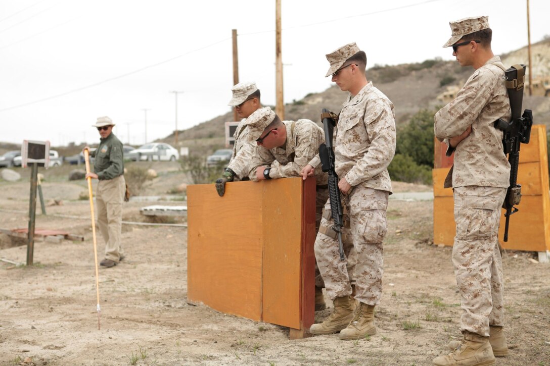 Marines with 1st Law Enforcement Battalion observe the proper technique used with the Holly Stick aboard Camp Pendleton, Calif., March 11. The Holly Stick is used to confirm the presence of suspected improvised explosive devices.
