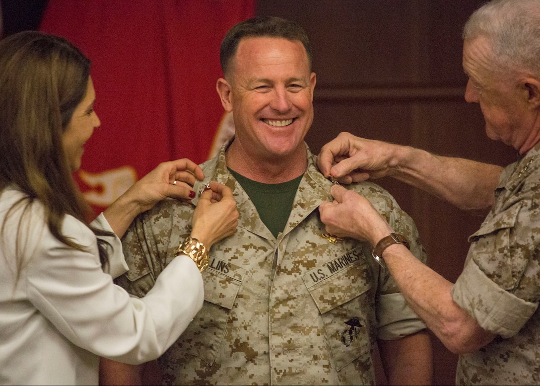 Maj. Gen. William T. Collins, the commanding general of the 4th Marine Aircraft Wing, Marine Forces Reserve, is promoted by Lt. Gen. Richard P. Mills, commander of MARFORRES, at the Marine Corps Support Facility New Orleans, March 16, 2014. His wife, Rosaelia Collins, attended the ceremony and helped pin on his new rank. Collins assumed command of the 4th MAW on Aug. 5, 2012.