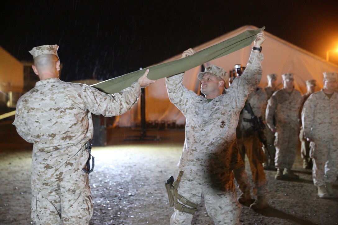 Sergeant Major Chasen Getty, left, sergeant major, 1st Battalion, 7th Marine Regiment, and Lt. Col. Seth Yost, right, commanding officer, 1st Bn., 7th Marines, uncase the battalion’s colors during a midnight transfer of authority ceremony aboard Camp Leatherneck, Afghanistan, March 15, 2014. After a seven-month deployment, 3rd Bn., 7th Marines, transferred their battlespace and responsibilities to 1st Bn., 7th Marines. “Our team is excited to do our part during a historic moment in the history of Afghanistan, and we’re able to do that with the support of our families.” said Lt. Col Seth Yost, the commanding officer of 1st Bn., 7th Marines.