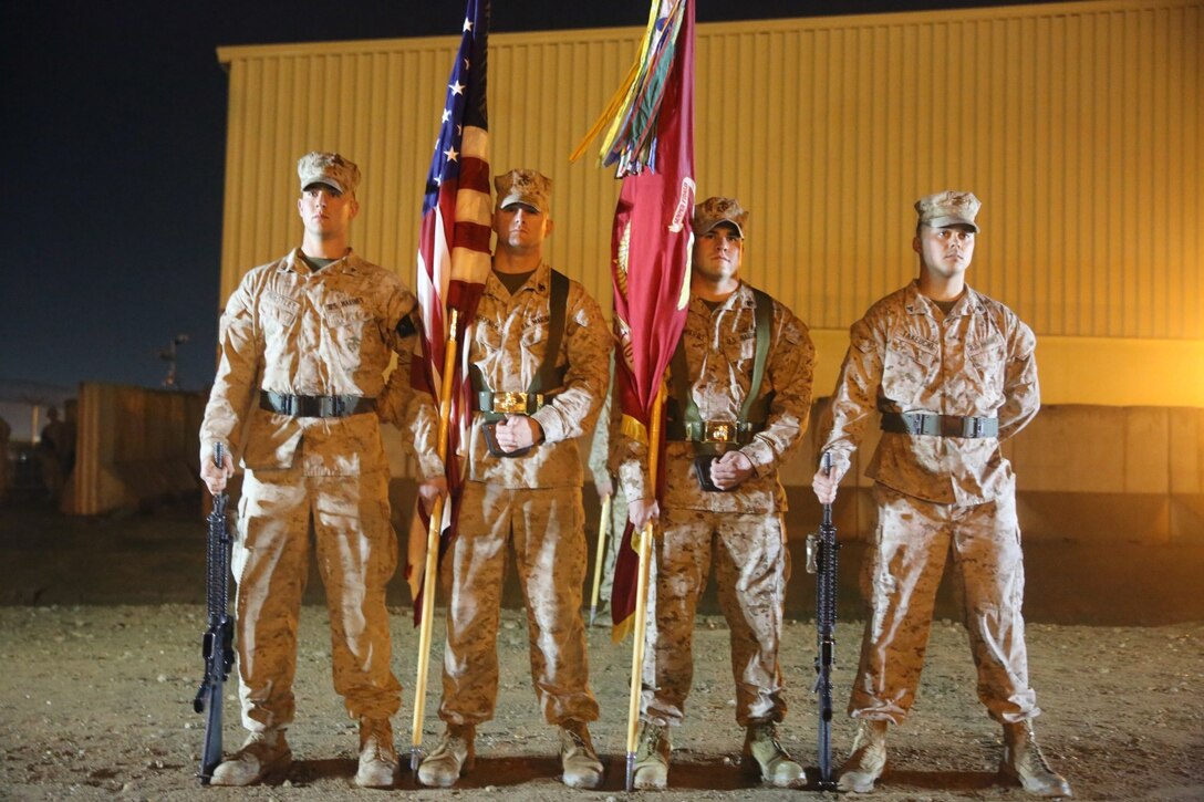 A color guard for 3rd Battalion, 7th Marine Regiment, stands in formation prior to a midnight transfer of authority ceremony aboard Camp Leatherneck, Afghanistan, March 15, 2014. After a seven-month deployment, 3rd Bn., 7th Marines, transferred their battlespace and responsibilities to 1st Battalion, 7th Marine Regiment. “Our team is excited to do our part during a historic moment in the history of Afghanistan, and we’re able to do that with the support of our families.” said Lt. Col Seth Yost, the commanding officer of 1st Bn., 7th Marines.
