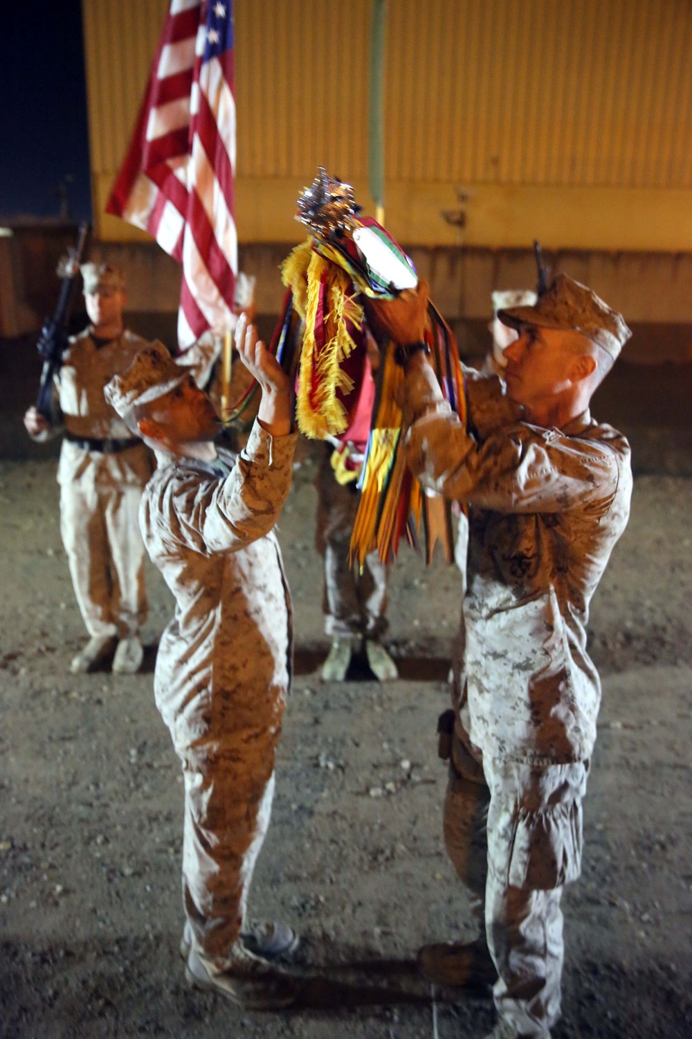 Sergeant Major Rafael Rodriguez, left, sergeant major, 3rd Battalion, 7th Marine Regiment, and Lt. Col. Dan Wittnam, right, commanding officer, 3rd Bn., 7th Marines, case their battalion’s colors during a midnight transfer of authority ceremony aboard Camp Leatherneck, Afghanistan, March 15, 2014. After a seven-month deployment, 3rd Bn., 7th Marines, transferred their battlespace and responsibilities to 1st Bn., 7th Marines. “Our team is excited to do our part during a historic moment in the history of Afghanistan, and we’re able to do that with the support of our families.” said Lt. Col Seth Yost, the commanding officer of 1st Bn., 7th Marines.