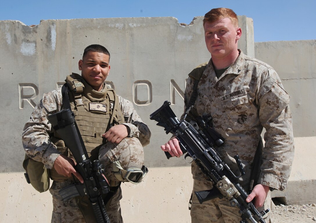 Lance Cpl. Donald Rucker, left, a maintenance administration clerk with Marine Heavy Helicopter Squadron 466, Marine Aircraft Group - Afghanistan, and Lance Cpl. Ian Smith, a mortarman with Weapons Company, 3rd Battalion, 7th Marine Regiment, pose for a photo after reuniting aboard Camp Leatherneck, Afghanistan, March 11, 2014. The brothers reconnected for the first time after being separated for more than a year and a half while serving in the Marine Corps. (U.S. Marine Corps photo by Cpl. Cody Haas/ Released)
