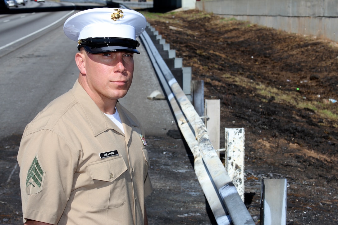 Sgt. Matthew Sullivan poses for a photo at the scene of an accident where he assisted a man injured after his truck caught on fire on I-85N at Old Peachtree Road, March 9. “Afterwards, when all the adrenaline recessed, I took a moment to pray for the man,” said Sullivan. “I really believe I was meant to be there that day to help him.” Sullivan is a recruiter with Recruiting Sub-Station Buford, Recruiting Station Atlanta. (U.S. Marine Corps photo by Sgt. Courtney G. White/released)
