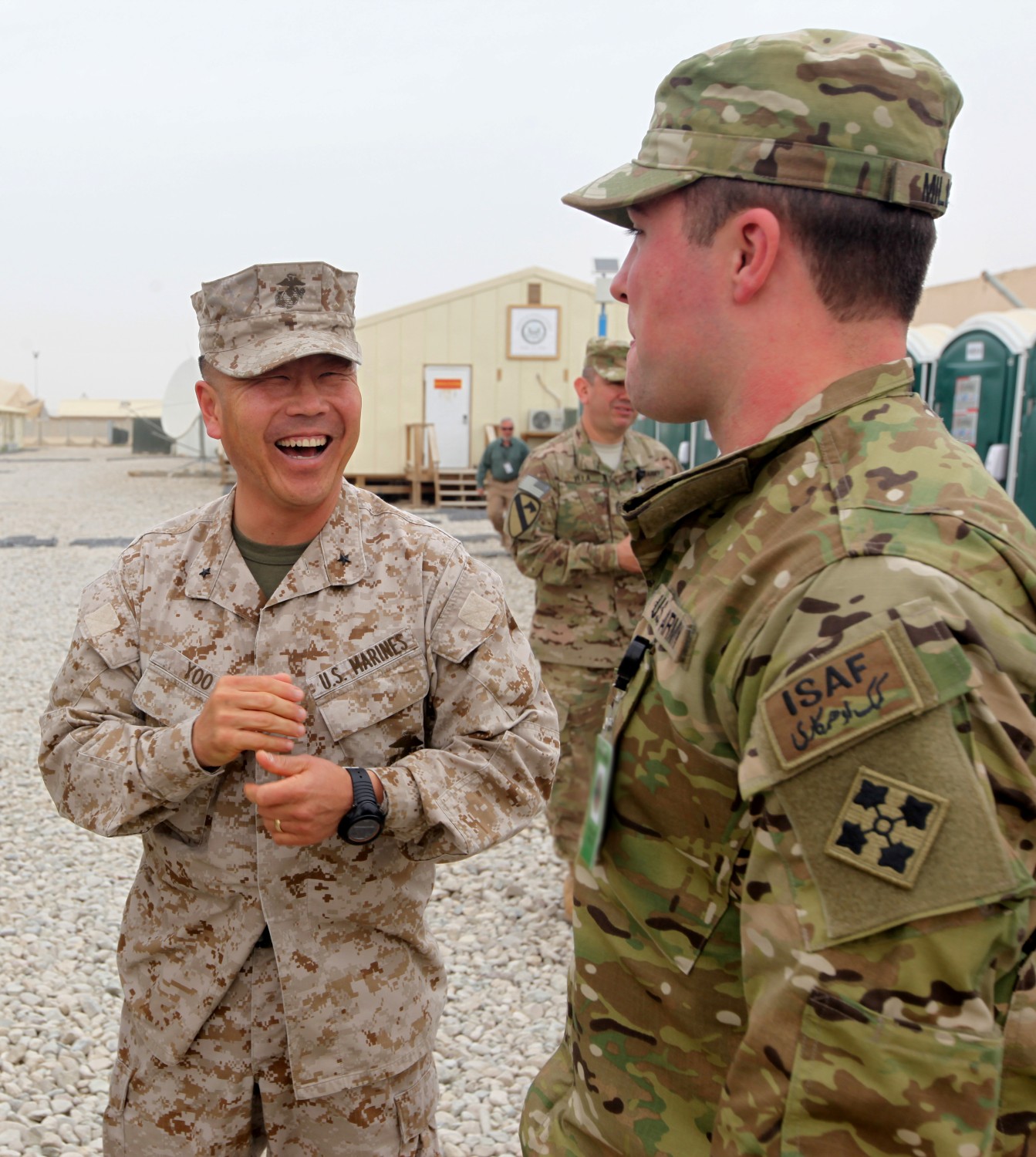 Brigadier Gen. Daniel Yoo, commanding general of Regional Command (Southwest), jokes with Spc. Andrew Miller (retired) before going to lunch with Miller and four other soldiers aboard Camp Leatherneck, Afghanistan, March 13, 2014. The soldiers were participants in Operation Proper Exit, a program for wounded service members who choose to come back to Afghanistan after recovering from combat injuries in order to find closure.