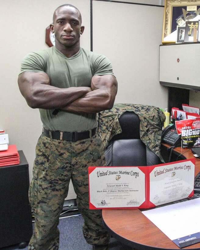 GARDEN CITY, N.Y. - Sgt. Malik S. King poses for a photograph Feb. 11 with the Honor Graduate award he received upon graduating from the Martial Arts Instructor Course. King graduated Honor Graduate from the MAI course in a class that started off with 23 Marines but only graduated 17. King, from Hempstead, N.Y., is the purchasing agent, warehouse chief, Color Sergeant, and now Martial Arts Instructor for the 1st Marine Corps District. (U.S. Marine Corps photo by Lance Cpl. Brandon Thomas).