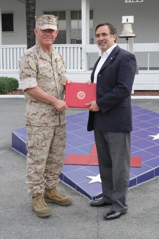 Henry Lanzziano, facility manager, 1st Marine Division, speaks to Maj. Gen. Lawrence Nicholson, commanding general, 1st Marine Division, and Marines serving with 1st Marine Division, during a retirement ceremony at Marine Corps Base Camp Pendleton, Calif., March 13, 2014. Lanzziano, a native of Madison, Wis., retired from his duties as facility manager after more than 30 years of service to the Marine Corps. Lanzziano was responsible for managing and up keeping facilities across the entire division.
