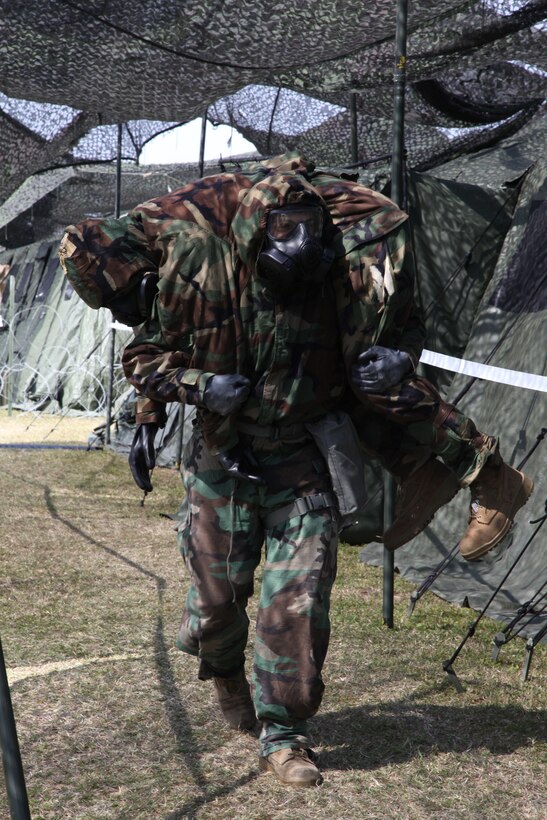 Cpl. David A. Lopez carries Lance Cpl. Dominic L. LaBeaf Feb. 25 during a gas attack drill as part of training scenario on Camp Kinser in preparation for Marine Expeditionary Force Exercise 14. During the training, Marines executed several scenarios designed to test the response time of Marines working in a combat operations center. Lopez is a data network specialist with Combat Logistics Regiment 37, 3rd Marine Logistics Group, III MEF. LaBeaf is a motor vehicle operator with 3rd MLG, III MEF. 