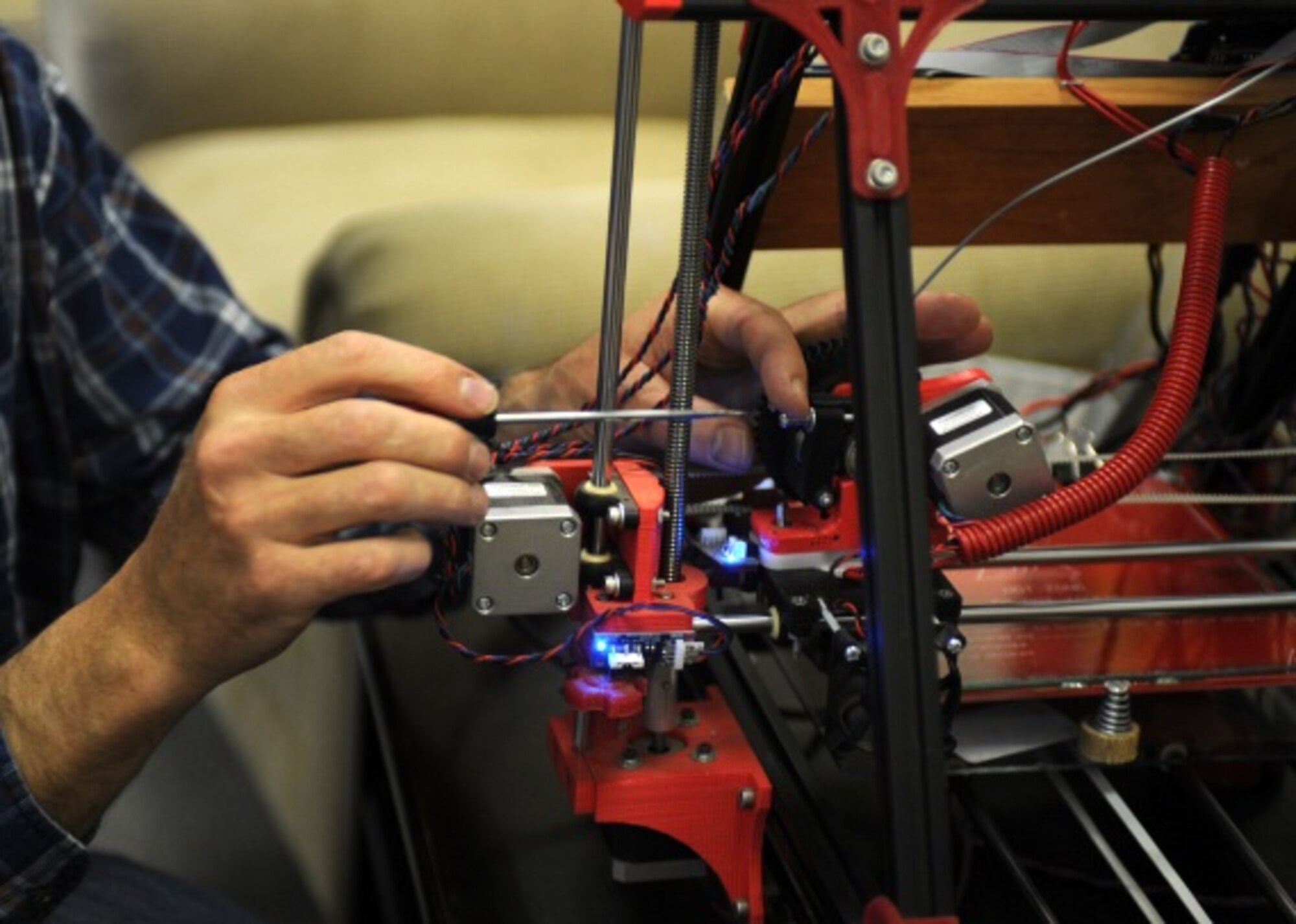 Ray Peters, 27th Special Operations Force Support Squadron technical information specialist, demonstrates 3-D printers capabilities March 11, 2014, at Cannon Air Force Base, N.M. The demonstration was part of the Technology Fair, where military members and civilians alike were encouraged to learn how to make the most of their technological resources.  (U.S. Air Force photo/ Senior Airman Ericka Engblom)
