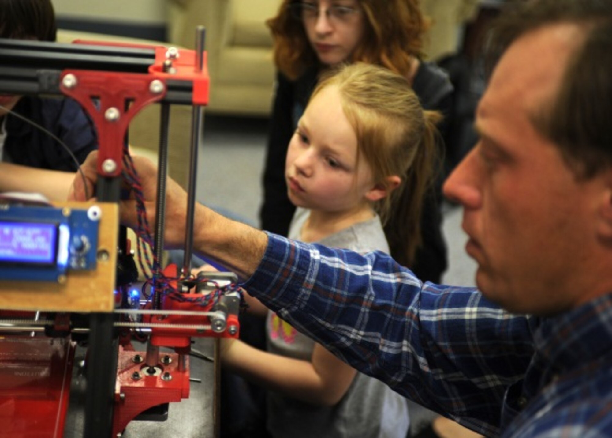 Ray Peters, 27th Special Operations Force Support Squadron technical information specialist, demonstrates 3-D printers capabilities March 11, 2014, at Cannon Air Force Base, N.M. The demonstration was part of the Technology Fair, where military members and civilians alike were encouraged to learn how to make the most of their technological resources.  (U.S. Air Force photo/ Senior Airman Ericka Engblom)