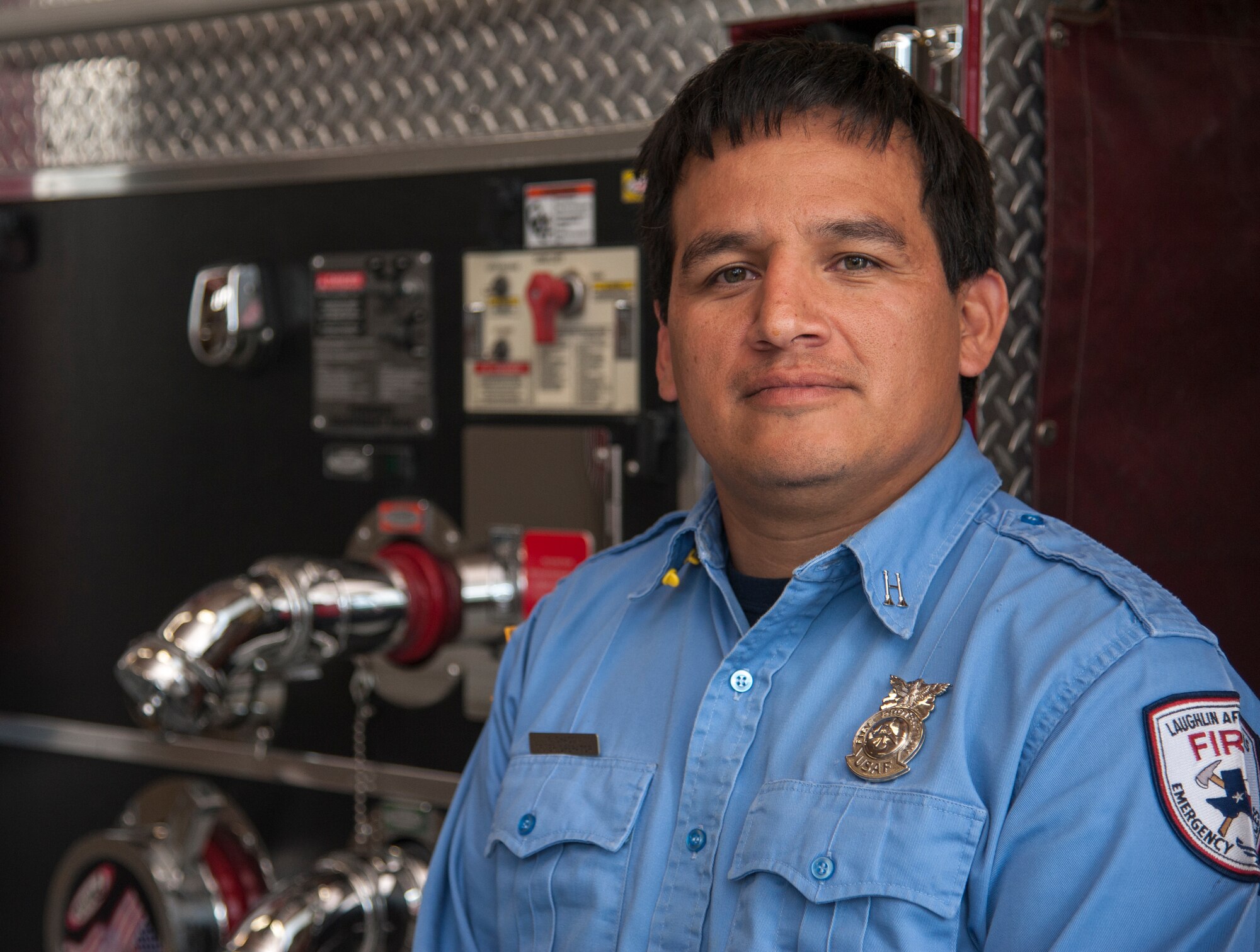 Miguel Chacon, 47th Civil Engineer Squadron lead firefighter, poses for a photo in front of a fire truck at the Laughlin Fire Department on Laughlin Air Force Base, Texas, March 11, 2014. Chacon was selected as the Air Education and Training Command’s 2013 Civilian Firefighter of the Year for his work with the Laughlin Fire Department. (U.S. Air Force photo/Senior Airman Nathan Maysonet)