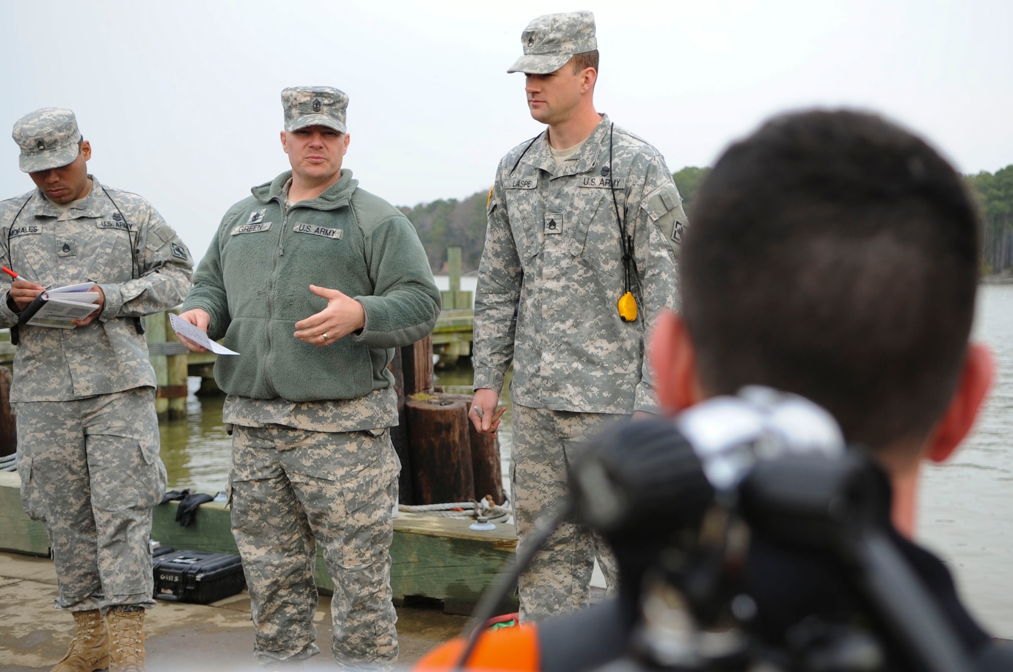 U.S. Army 1st Sgt. Christopher Green, 74th Engineer Detachment (Dive), 30th Engineer Battalion, 20th Engineer Brigade first sergeant, briefs a dive team before a training scenario at Fort Eustis, Va., March 12, 2014. Divers go through two phases of training before being assigned to a unit. (U.S. Air Force photo by Senior Airman Austin Harvill/Released)
