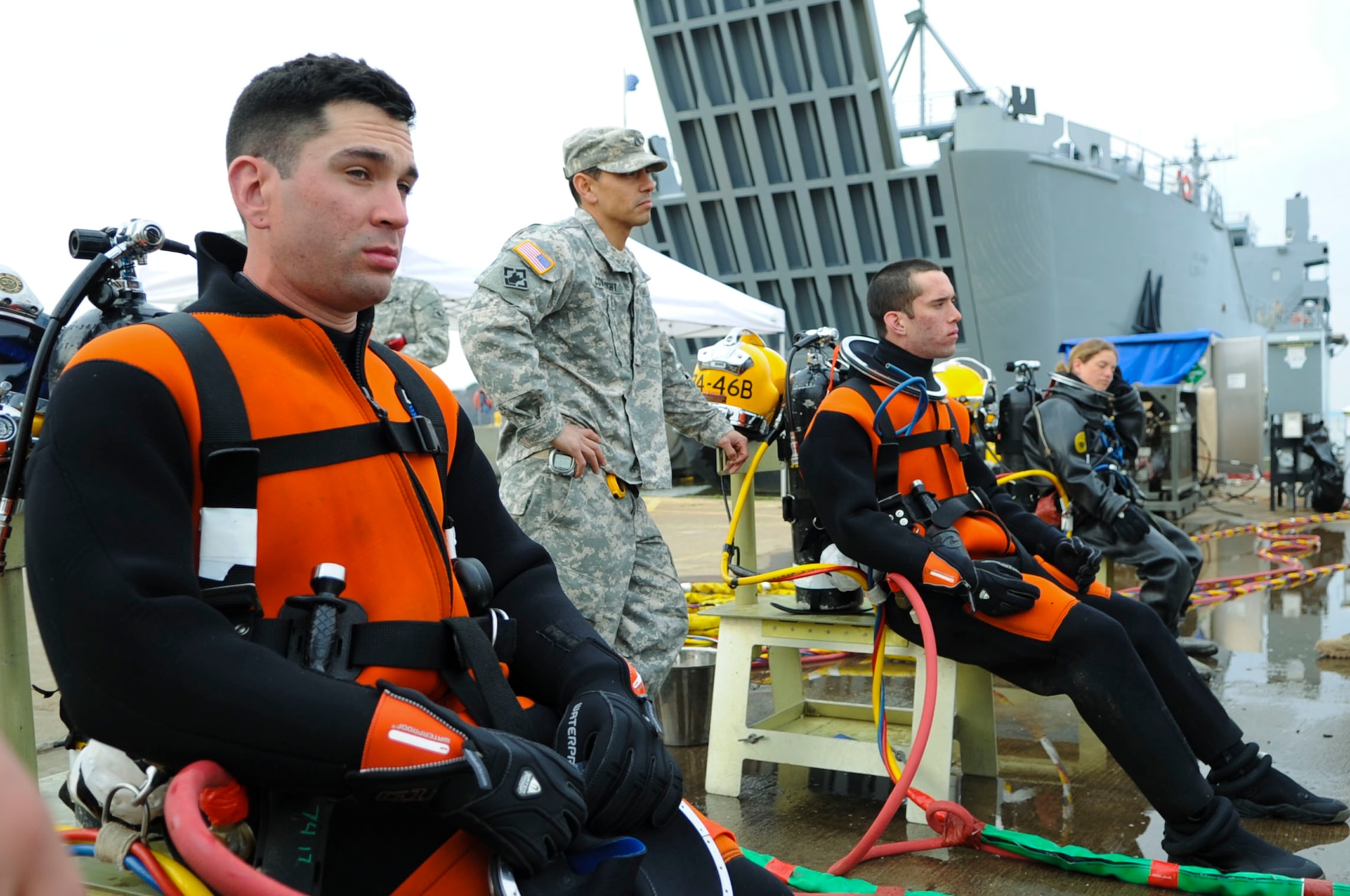 The 74th Engineer Detachment (Dive), 30th Engineer Battalion, 20th Engineer Brigade dive team prepares to dive before a training scenario at Fort Eustis, Va., March 12, 2014. After assignment to a unit, divers still undergo in-the-job training to enhance their skills. (U.S. Air Force photo by Senior Airman Austin Harvill/Released)