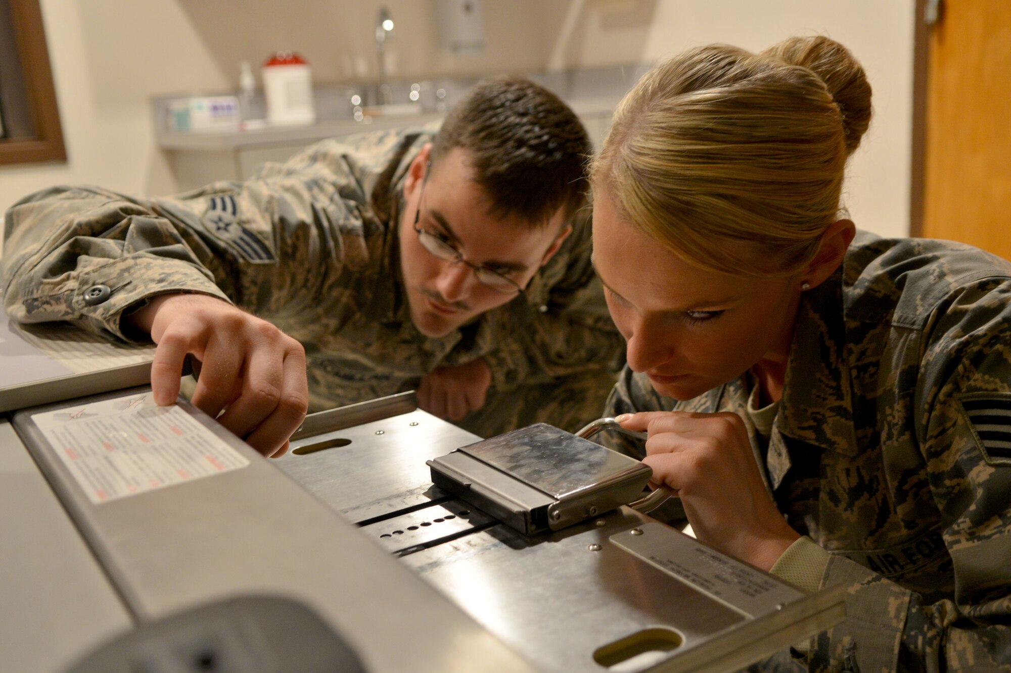 U.S. Air Force Senior Airman James McMillian, 20th Medical Support Squadron medical maintenance technician, and Staff Sgt. Lauren Key, 20th MDSS medical maintenance NCO in charge work together to complete an annual X-ray calibration for the year, Shaw Air Force Base, S.C., March 13, 2014. The purpose of the calibration is to ensure the X-ray results on an individual are as close to accurate as possible and so the patient is not harmed or has false reading. (U.S. Air Force photo by Senior Airman Ashley L. Gardner/Released)