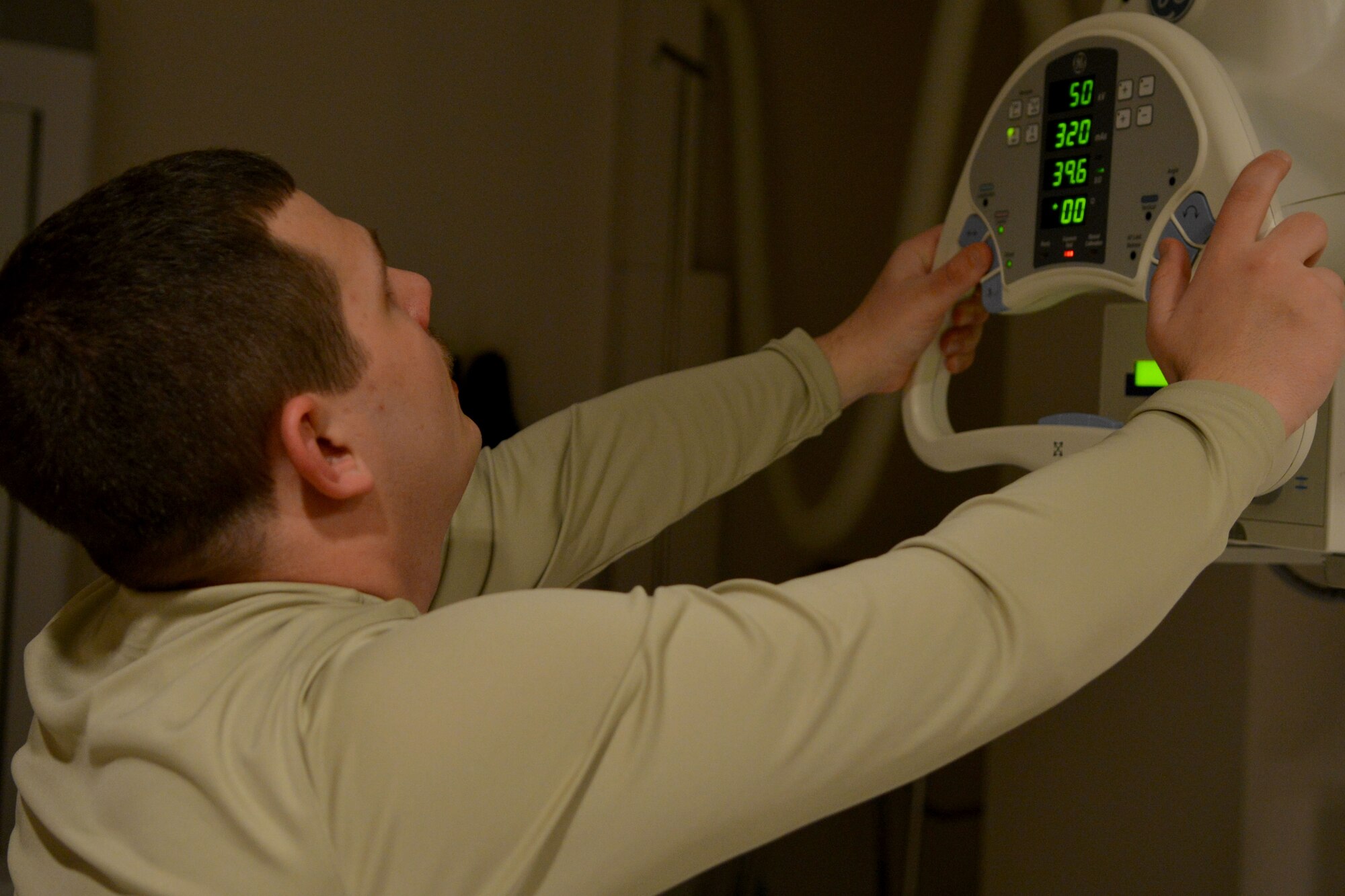 U.S. Air Force Senior Airman Jeremy Nott, 20th Medical Support Squadron medical maintenance technician, positions an X-ray machine to begin its calibration, Shaw Air Force Base, S.C., March 13, 2014. The process for calibration normally takes eight to 12 hours depending on what circumstances the medical technicians find. (U.S. Air Force photo by Senior Airman Ashley L. Gardner/Released)