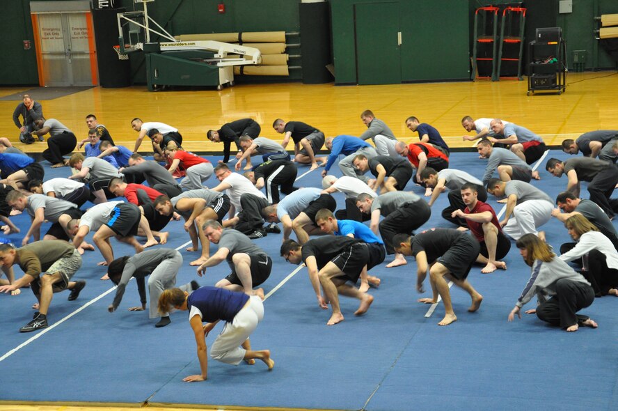 Ninety Airmen from Wright-Patterson AFB, along with ten participants from Wright State University, practice how to rise from a vulnerable seated position during the first day of a 40-hours self-defense instructor course at Wright State University March 10. The program, Gracie Defense Systems, designed by Gracie Global specifically for the military, is part of a research partnership between Wright-Patterson AFB and Wright State University that will certify participating Airmen to teach self-defense to others. 