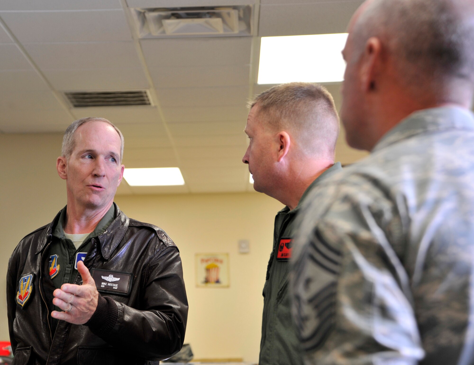 Gen. Mike Hostage, commander of Air Combat Command, talks with Col. James Cluff, 432nd Wing/432nd Air Expeditionary Wing commander, and Chief Master Sgt. Butch Brien, 432nd Wing command chief master sergeant, about the Creech Airman Ministry Center March 3, 2014. Hostage toured the base to see firsthand the quality-of-life issues Creech Airmen and their families face. (U.S. Air Force photo by Airman 1st Class C.C./released)
