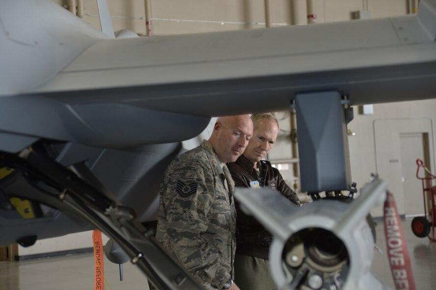 Tech. Sgt. Robert, 432nd Aircraft Maintenance Squadron expediter, explains the capabilities of an MQ-9 Reaper to Gen. Mike Hostage, commander of Air Combat Command, March 3, 2014. Hostage toured the base to discuss the quality-of-life issues facing Airmen and their families.  (U.S. Air Force photo by Staff Sgt. A.K./released)