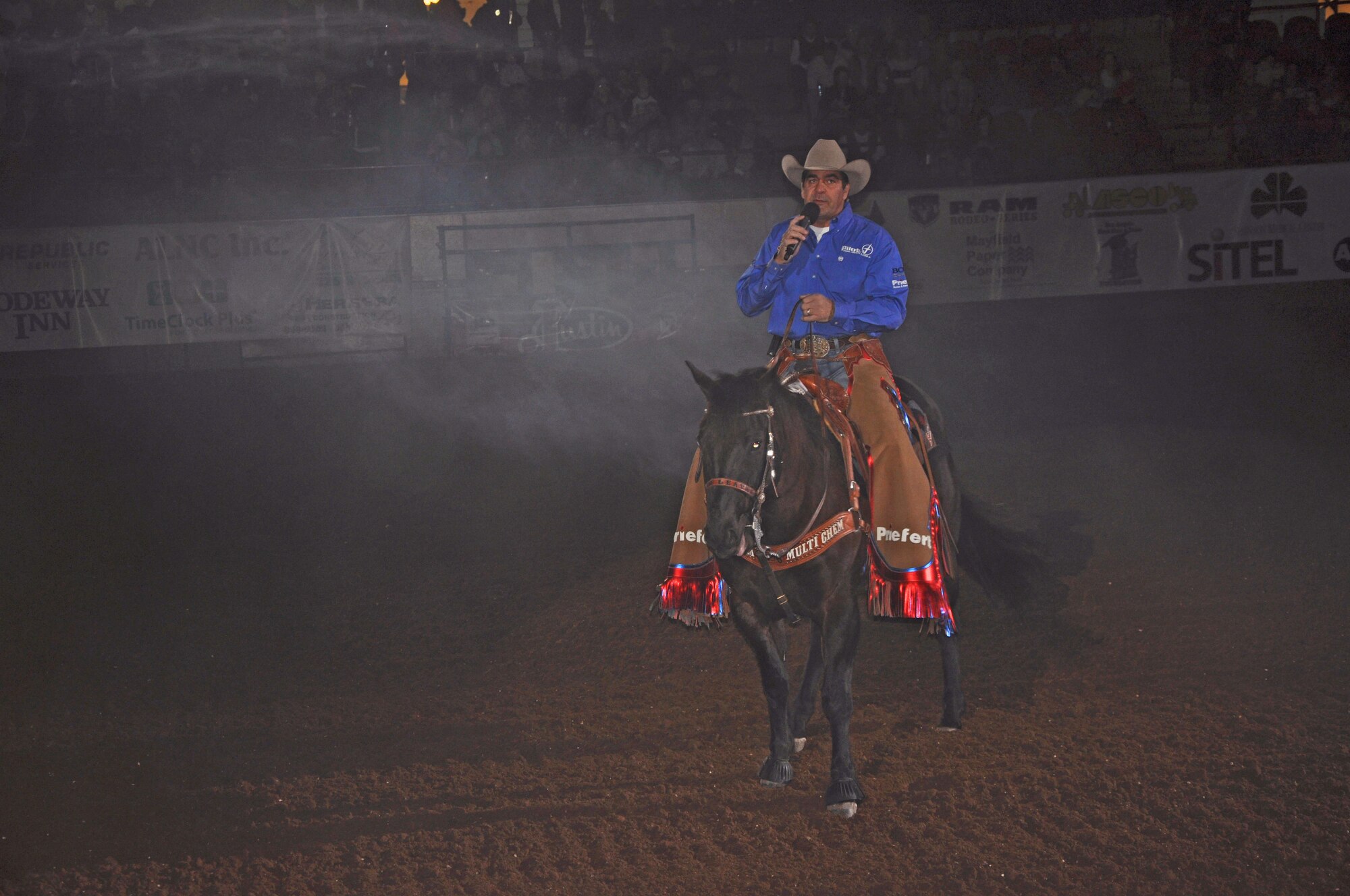 SAN ANGELO, Texas – Boyd Polhamus, San Angelo Stock Show and Rodeo announcer, speaks during the opening of the San Angelo Stock Show and Rodeo’s Military Appreciation Night at the Foster Communication Coliseum here Feb. 26. Military Appreciation Night is recognized annually during the rodeo. (U.S. Air Force photo/ Airman 1st Class Breonna Veal)