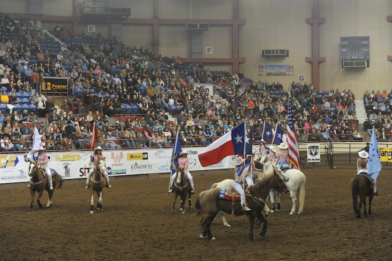 SAN ANGELO, Texas --The San Angelo Stock Show and Rodeo Drill Team Ambassadors present the American and service flags during the San Angelo Stock Show and Rodeo’s Military Appreciation Night at the Foster Communication Coliseum here Feb. 26. Goodfellow Air Force Base’s Patriotic Blue sang the national anthem during the flag presentation. (U.S. Air Force photo/ Staff Sgt. Laura R. McFarlane)

