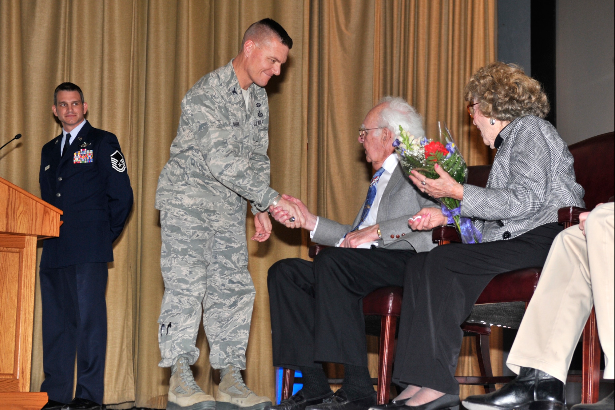 GOODFELLOW AIR FORCE BASE, Texas -- Col. Brendan Harris, 17th Training Group Commander, presents William Archer, World War II Boeing B-17 Flying Fortress co-pilot, with a commander’s coin after the Q-and-A session at the base theater here March 7. Although Archer was discharged after the war, he remained in the reserves until he obtained the rank of captain. (U.S. Air Force photo/ Airman 1st Class Devin Boyer)