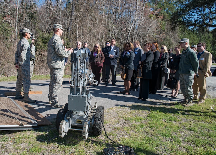 Staff Sgt. Edward Garwick, 628th Civil Engineer Squadron Explosives Ordinance Unit, and other EOD members, brief the Honorary Commanders on the EOD mission March 13, 2014, during the Honorary Commanders orientation tour of JB Charleston-Air Base, S.C. The Joint Base Charleston Honorary Commanders Program encourages an exchange of ideas, experiences, and friendship between key members of the local civilian community and the Charleston military community.  The program provides a unique opportunity for members of the Charleston area to shadow commanders of Air Force wings and groups as well as Navy and tenant units at Joint Base Charleston. (U.S. Air Force photo/Senior Airman Ashlee Galloway)