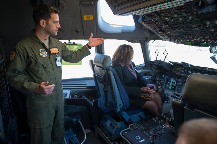 Capt. Brian Butler, 16th Airlift Squadron pilot, explains the C-17 Globemaster III cockpit to the several Honorary Commanders March 13, 2014, during the Honorary Commander orientation tour of JB Charleston-Air Base, S.C. The Joint Base Charleston Honorary Commanders Program encourages an exchange of ideas, experiences and friendship between key members of the local civilian community and the Charleston military community. The program provides a unique opportunity for members of the Charleston area to shadow commanders of Air Force wings and groups as well as Navy and tenant units at Joint Base Charleston. (U.S. Air Force photo/Senior Airman Ashlee Galloway)