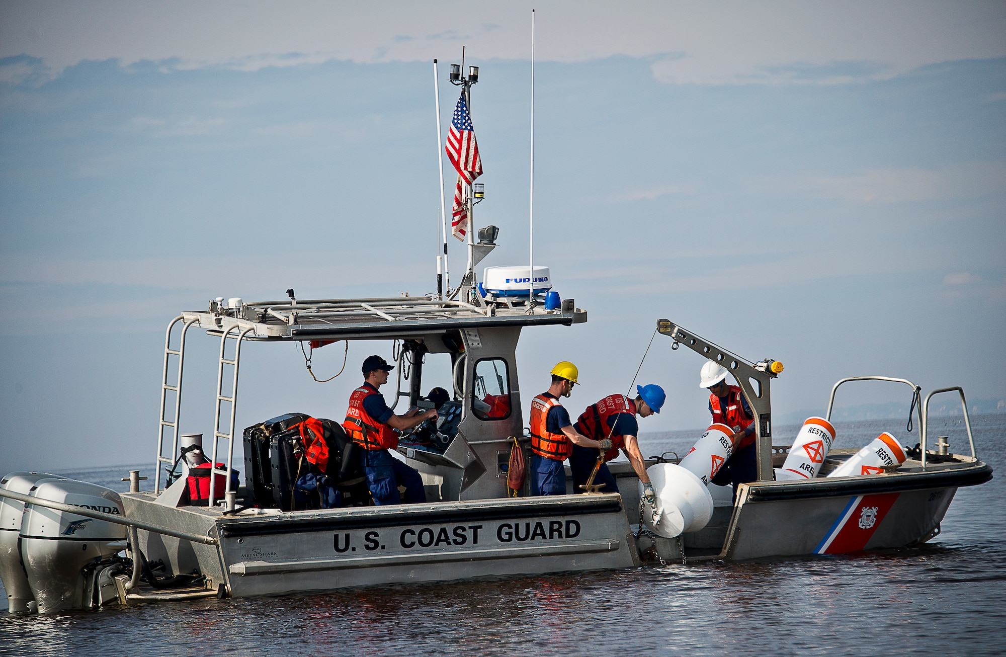 Aids to Navigation Team members from Coast Guard Station Pensacola prepare to post a restricted area buoy March 11 at Eglin Air Force Base, Fla.  The Coast Guard posted approximately 40 buoys along the base’s coastline from Post’l Point to the Bayview Club.  The anchored buoys, spread approximately 700 feet from each other, are a force protection enterprise by the base to identify Eglin waterways.  According to the code of federal regulations (CFR 334.700-748), all vessels and other craft are permitted access to the restricted area, but could be subject to identification checks by Air Force patrol boats.  During times of high security threats against Eglin or Hurlburt Field, all entry, transit, anchoring or drifting within the restricted areas is prohibited without permission from the respective base commander or authorized representative.  (U.S. Air Force photo/Samuel King Jr.)