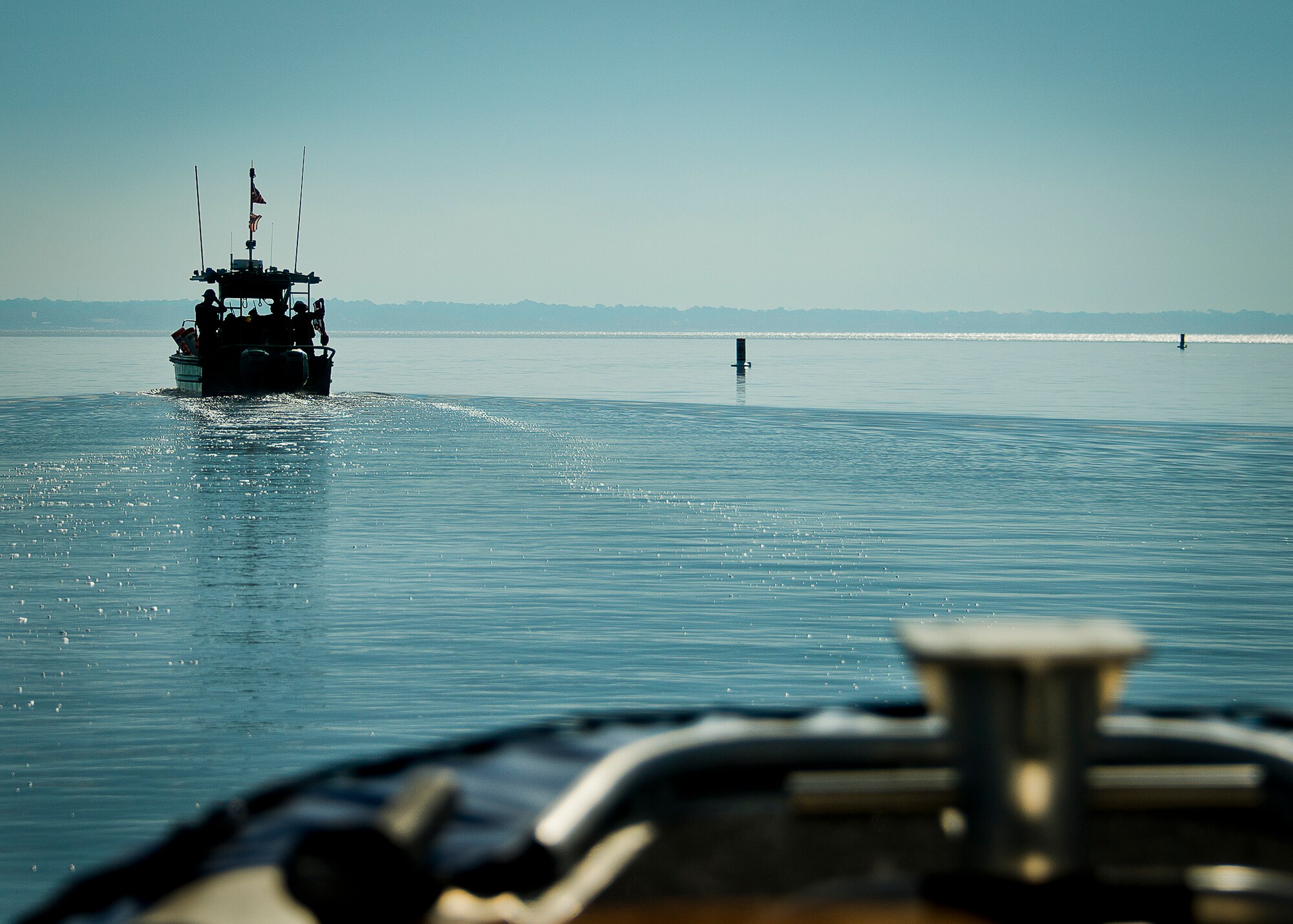 A Coast Guard Station Pensacola boat carries out restricted area buoys bound for the coastline of Eglin Air Force Base, Fla., March 11.   The Coast Guard posted approximately 40 buoys along the base’s coastline from Post’l Point to the Bayview Club.  The anchored buoys, spread approximately 700 feet from each other, are a force protection enterprise by the base to identify Eglin waterways.  According to the code of federal regulations (CFR 334.700-748), all vessels and other craft are permitted access to the restricted area, but could be subject to identification checks by Air Force patrol boats.  During times of high security threats against Eglin or Hurlburt Field, all entry, transit, anchoring or drifting within the restricted areas is prohibited without permission from the respective base commander or authorized representative.  (U.S. Air Force photo/Samuel King Jr.)