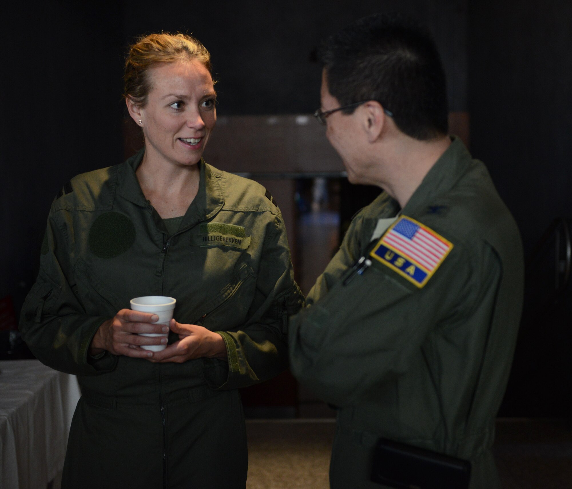 RAMSTEIN AIR BASE, Germany – Capt. Sjaane Hilligehekken, Royal Netherlands air force flight surgeon, enjoys some conversation with one of the attendees of the 29th Annual Aerospace Medicine Summit and NATO Science and Technology Organization Technical Course at the Hercules Theater here March 10, 2014. Hilligehekken joined more than 170 medical professionals from 16 nations at the summit, a joint effort between the U.S. Air Force’s in Europe-Air Forces Africa Surgeon General’s office and NATO to share information in the aerospace medical world and build relationships with international partners. (U.S. Air Force Photo by Tech. Sgt. James M. Hodgman)