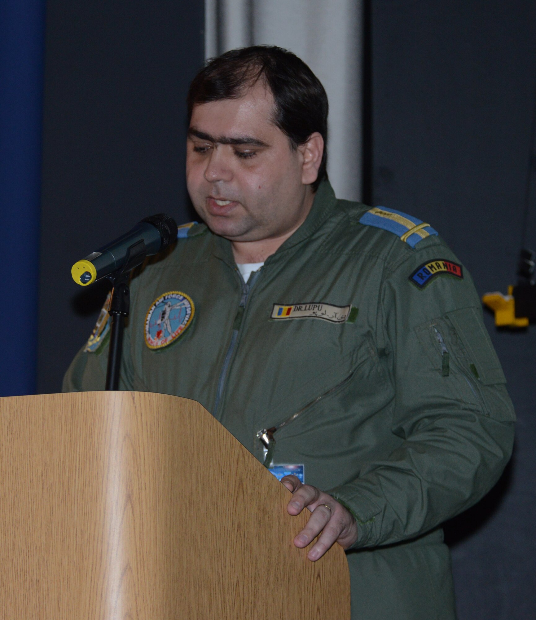 RAMSTEIN AIR BASE, Germany – Maj. Leonard I. Lupu, a Romanian air force flight surgeon, shares the history of Romanian flight medicine with more than 170 medical professionals at the 29th Annual Aerospace Medicine Summit and NATO Science and Technology Organization Technical Course at the Hercules Theater here March 11, 2014. Lupu has attended the summit five times and said he’s thankful for the partnership Romania has with U.S. Air Forces in Europe and Air Forces Africa, as well as NATO.   (U.S. Air Force Photo by Tech. Sgt. James M. Hodgman)