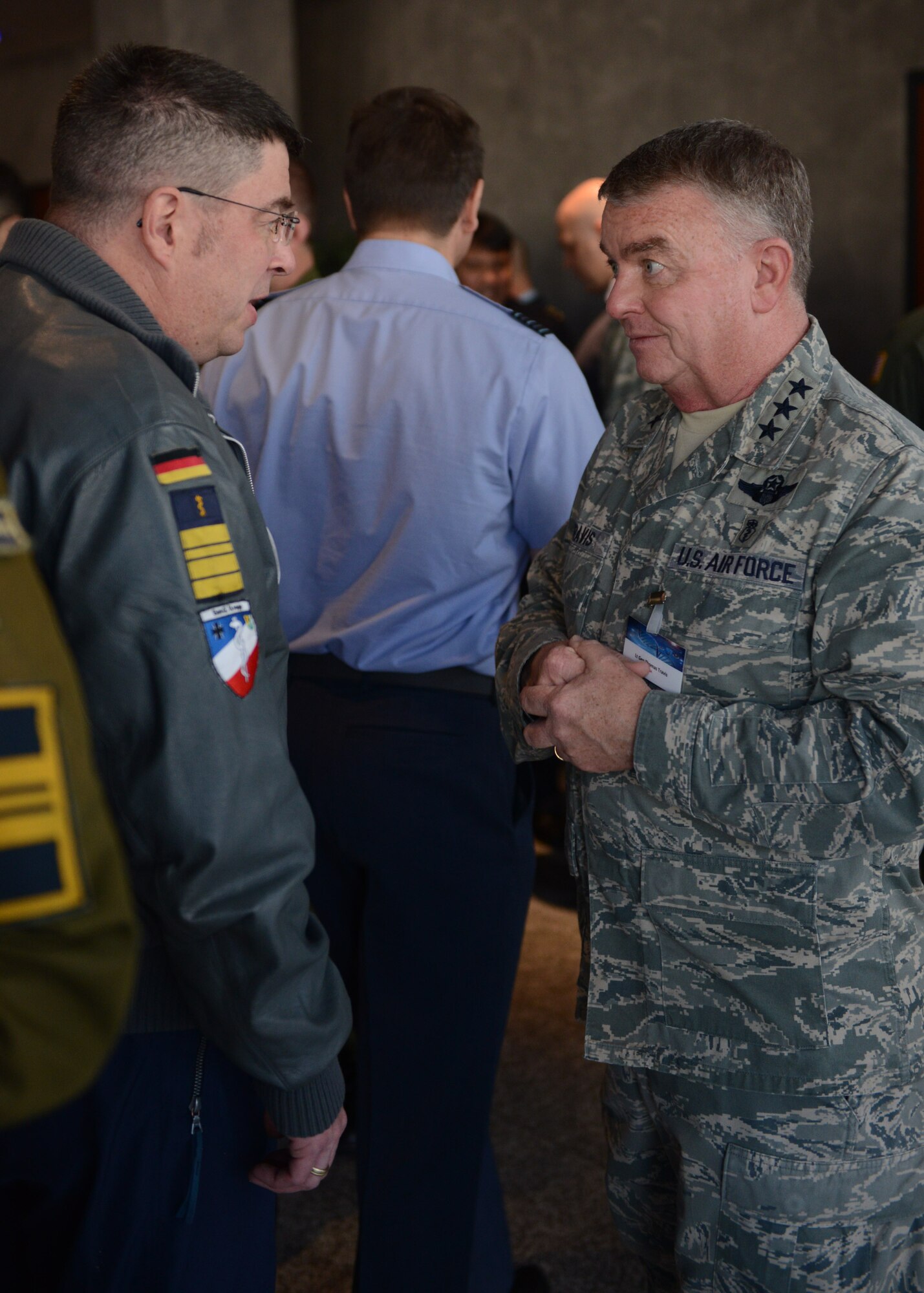 RAMSTEIN AIR BASE, Germany -- Dr. Joachim Koch (Left), flight surgeon commander with the German navy, chats with Lt. Gen. Thomas W. Travis (Right), U.S. Air Force surgeon general, during a break at the 29th Annual Aerospace Medicine Summit and NATO Science and Technology Organization Technical Course at the Hercules Theater here March 10, 2014. The summit is a joint effort between the USAFE-AFAFRICA Surgeon General’s office and NATO to share information in the aerospace medical world and build relationships with international partners.  (U.S. Air Force Photo by Tech. Sgt. James M. Hodgman)