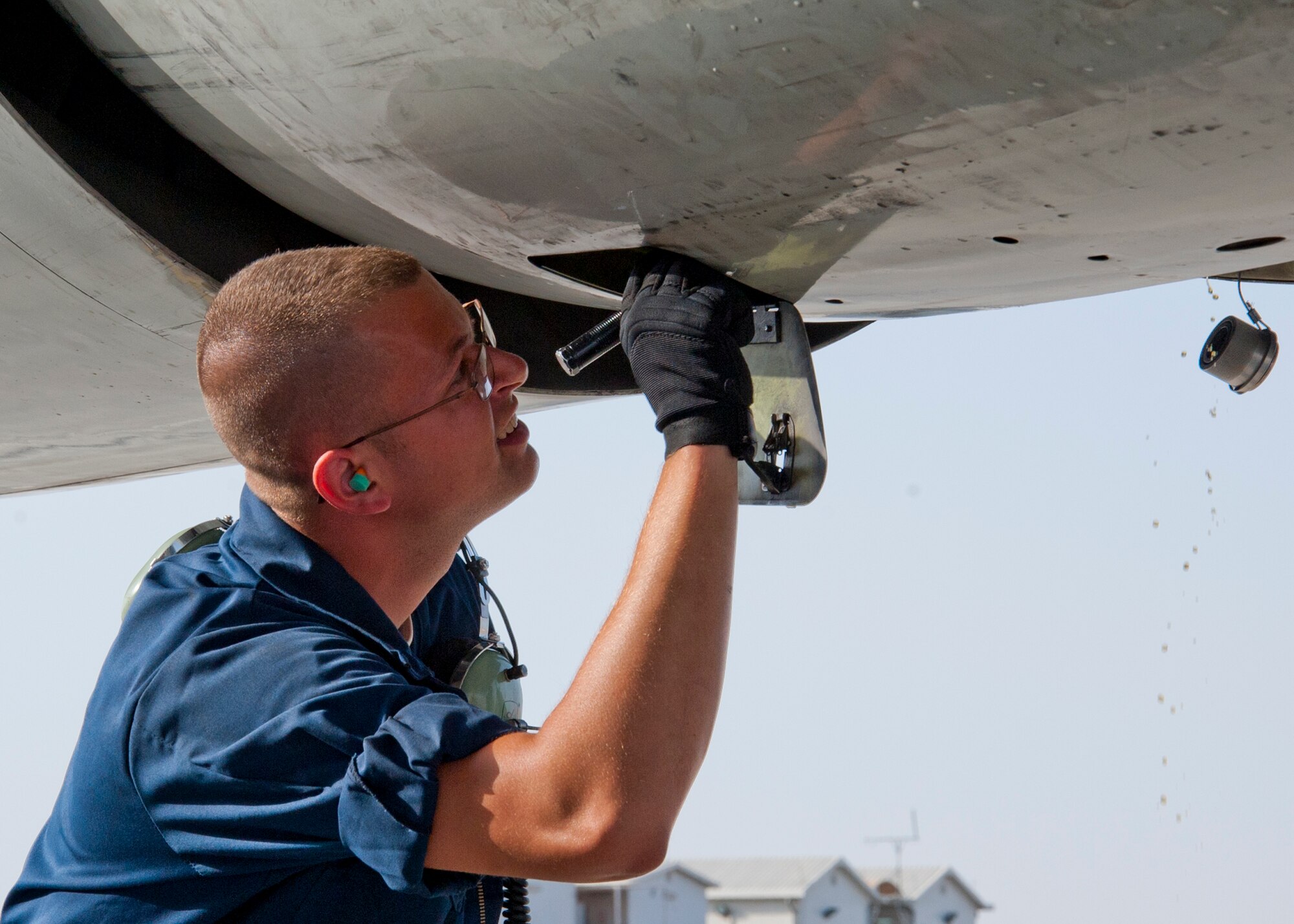 Air Force Senior Airman Todd Pagett, 380th Expeditionary Aircraft Maintenance Squadron Sentry Aircraft Maintenance Unit E-3 fuels technician, inspects an integrated drive generator  on an E-3 Sentry after it was services at an undisclosed location in Southwest Asia, March 12, 2014. Padgett is a native of Terre Haute, Ind., and is deployed from Tinker Air Force Base, Okla. (U.S. Air Force photo by Staff Sgt. Michael Means/Released)