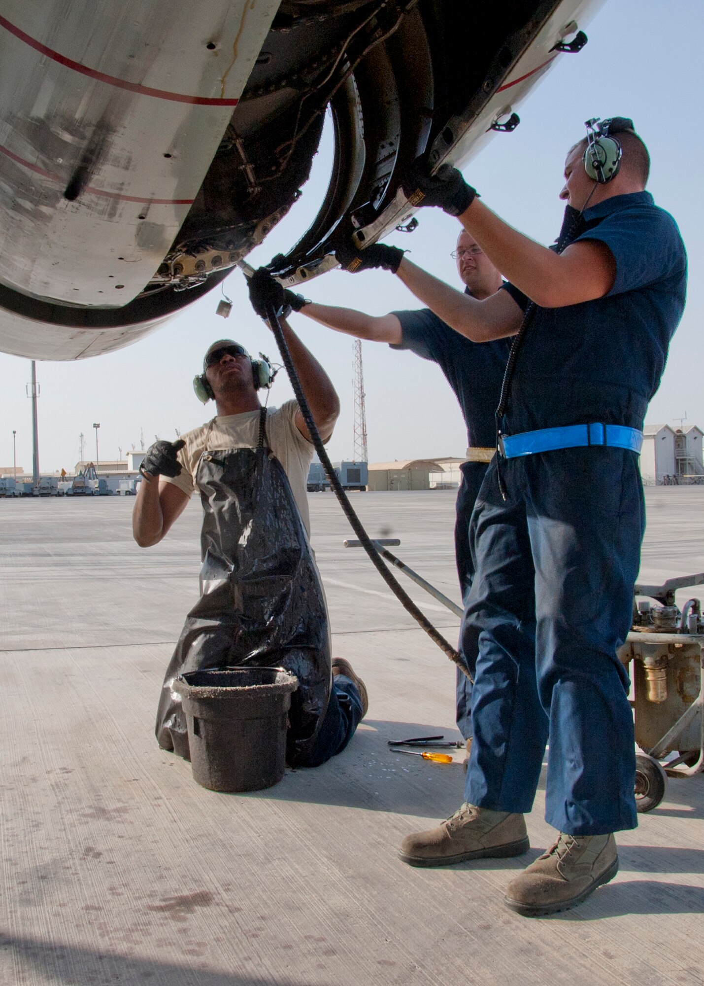 Air Force Senior Airman William Smith, 380th Expeditionary Aircraft Maintenance Squadron Sentry Aircraft Maintenance Unit E-3 engines technician, services an integrated drive generator on an E-3 Sentry at an undisclosed location in Southwest Asia, March 12, 2014. Smith is a native of Phoenix, Ariz., and is deployed from Tinker Air Force Base, Okla. (U.S. Air Force photo by Staff Sgt. Michael Means/Released)