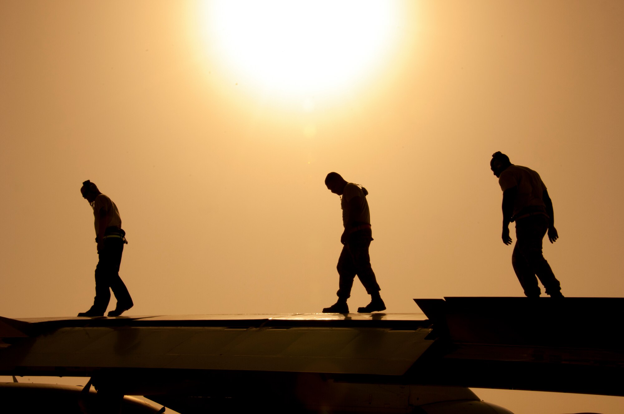 Air Force Staff Sgt. Willima Reyer, Air Force Airman 1st Class Cristiam Araujo and Air Force Senior Airman Clifford Scott, all maintainer assigned to the 380th Expeditionary Aircraft Squadron Sentry Aircraft Maintenance Unit, perform a post flight wing inspection on an E-3 Sentry at an undisclosed location in Southwest Asia, March 12, 2014. The Airmen are deployed from Tinker Air Force Base, Okla. (U.S. Air Force photo by Staff Sgt. Michael Means/Released)