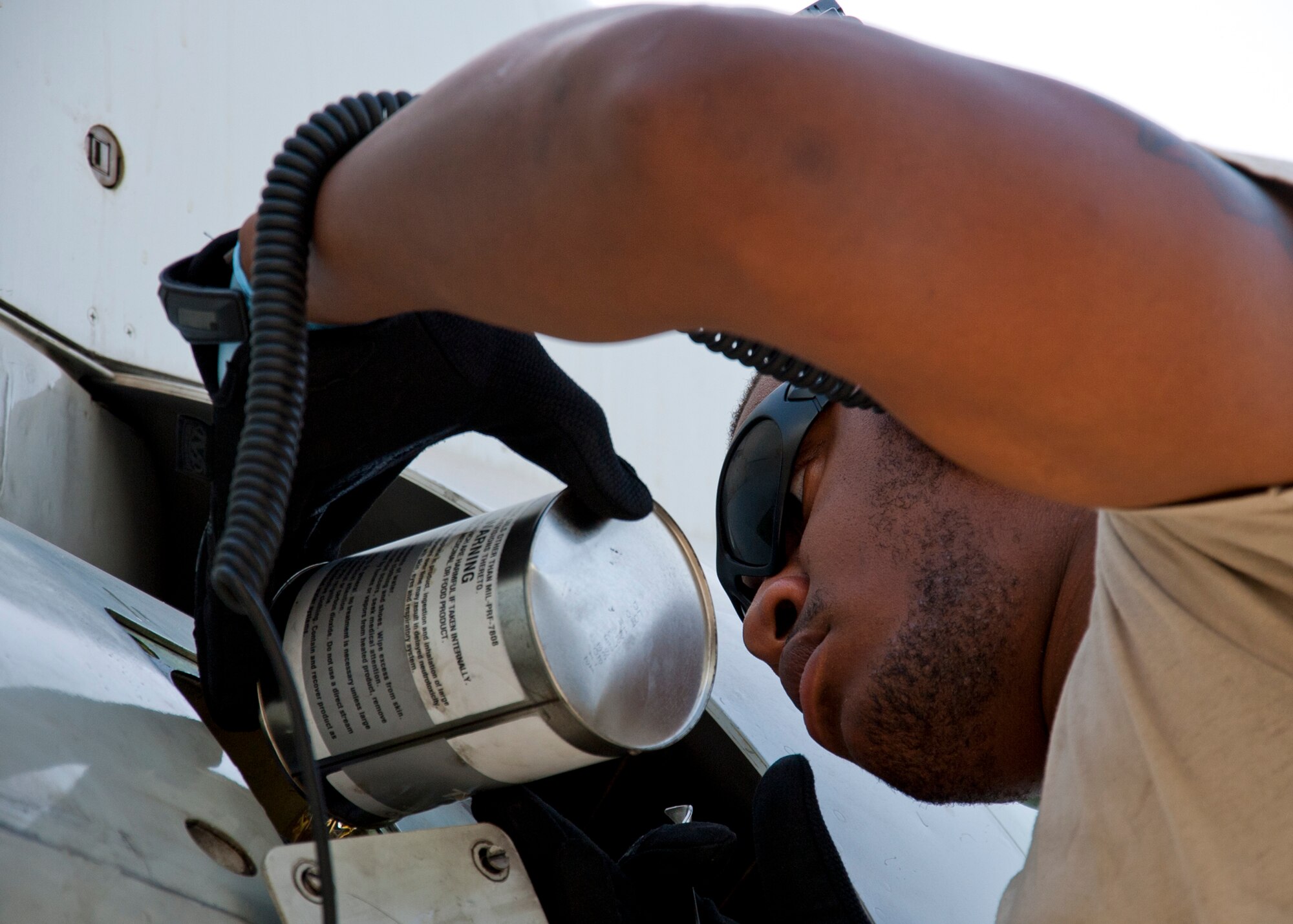 Air Force Senior Airman William Smith, 380th Expeditionary Aircraft Maintenance Squadron Sentry Aircraft Maintenance Unit E-3 engines technician, services oil on a E-3 Sentry at an undisclosed location in Southwest Asia, March 12, 2014. Smith is a native of Phoenix, Ariz., and is deployed from Tinker Air Force Base, Okla. (U.S. Air Force photo by Staff Sgt. Michael Means/Released)