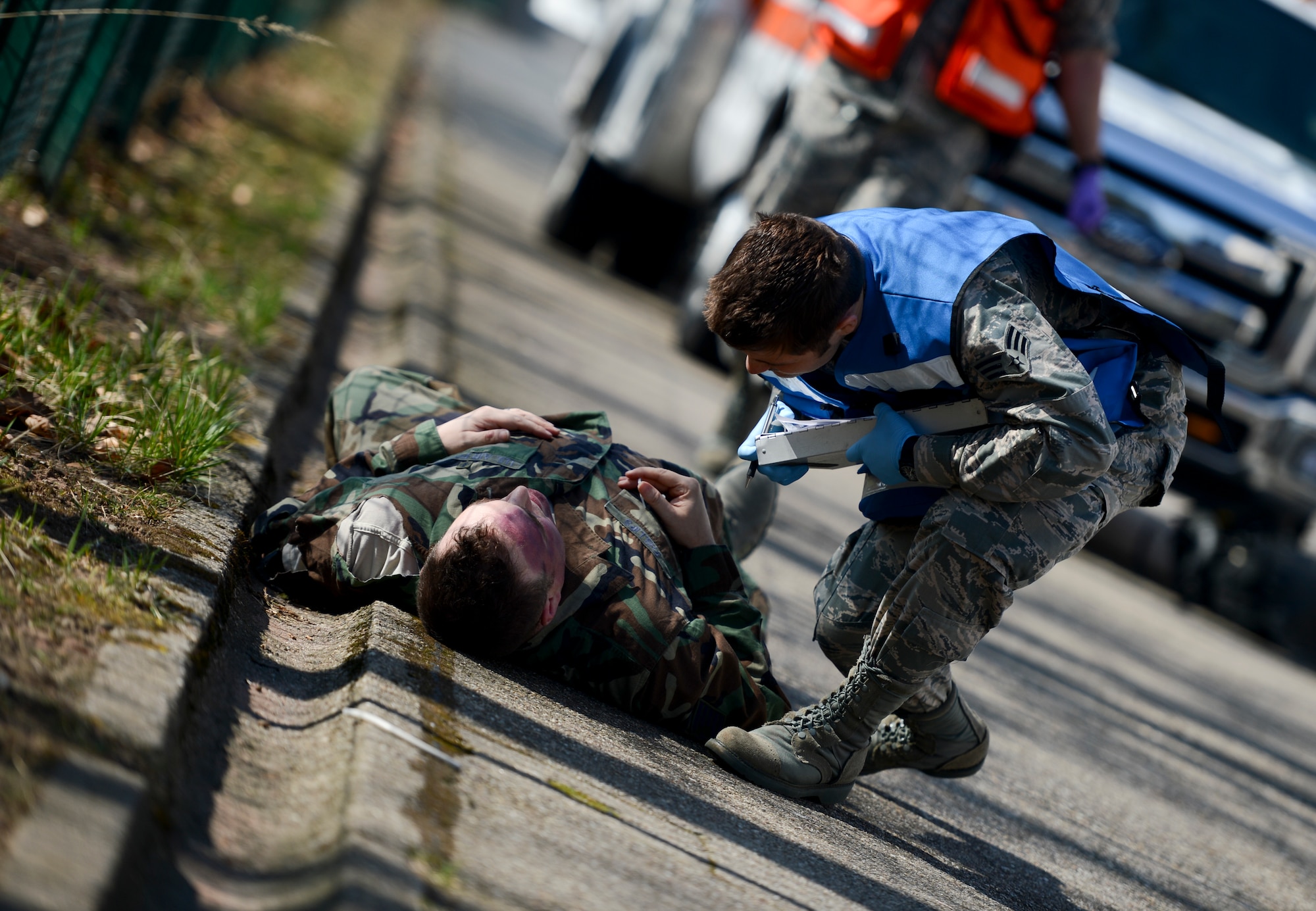 A first responder checks for respiration, perfusions and the mental status of a victim during a mass casualty training March 13, 2014, Ramstein Air Base, Germany. The 86th Medical Group hosted a mass casualty training to familiarize first responders with the scene of a disaster or a catastrophe. (U.S. Air Force Photo/Airman 1st Class Michael Stuart)