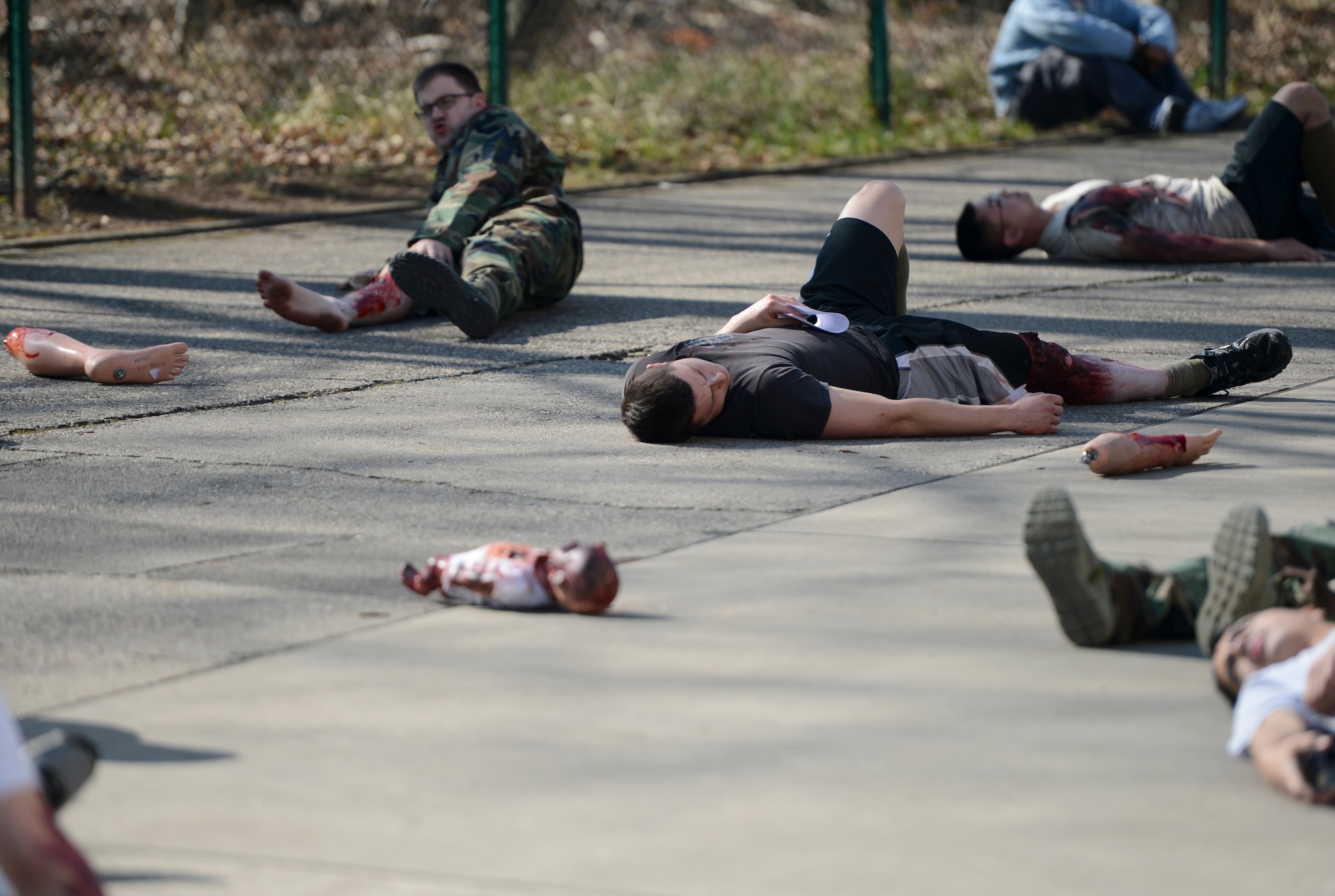 Mass casualty training victims lay astray as they wait on medical attention March 13, 2014, Ramstein Air Base, Germany. Multiple squadrons from the 86th Medical Group conducted a 3 hour mass casualty exercise to acquaint first responders with a scenario similar to a real-life situation. (U.S. Air Force Photo/Airman 1st Class Michael Stuart)