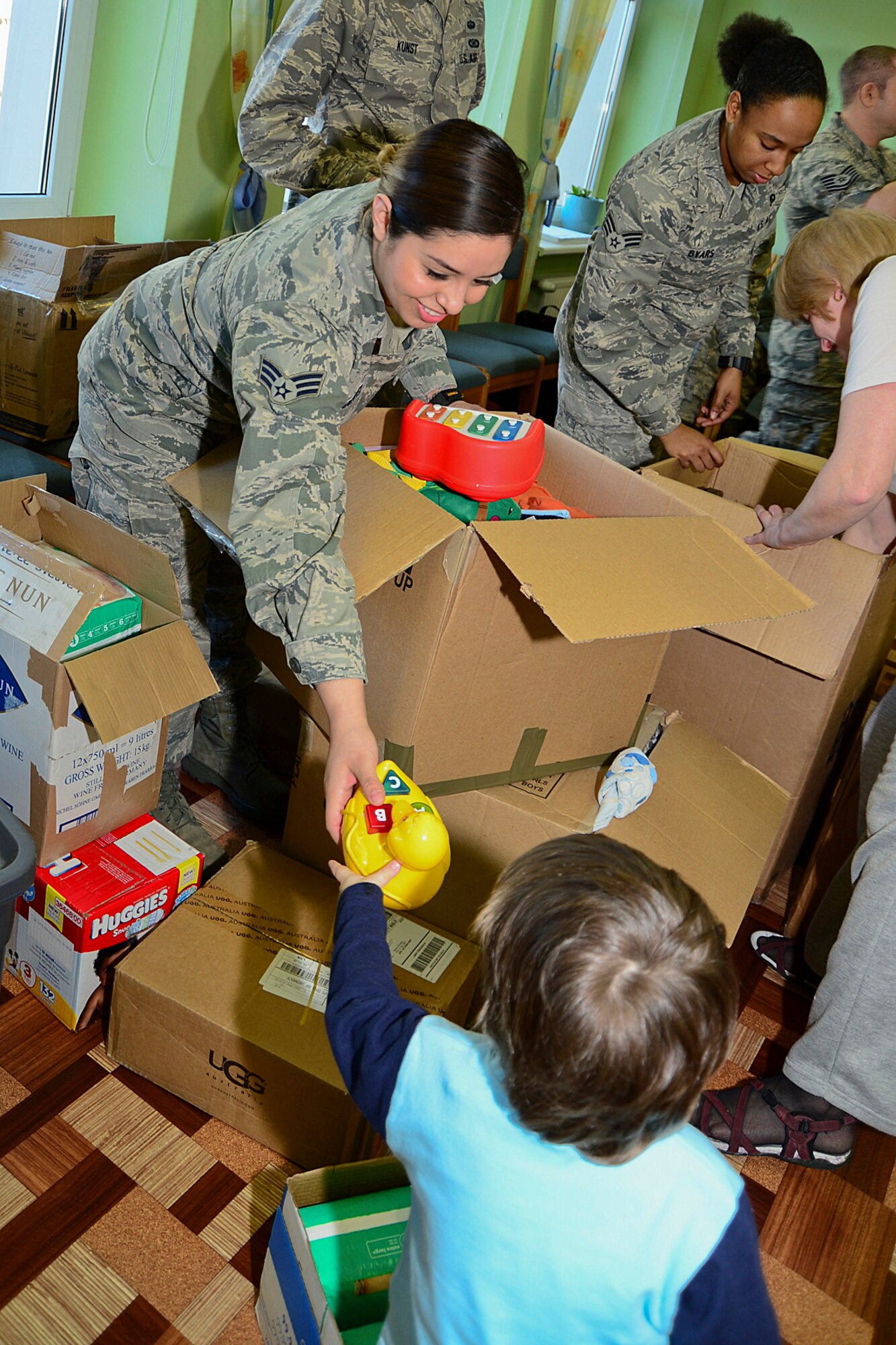 Senior Airman Yazmine Esquivel, 48th Air Expeditionary Group maintenance supply journeyman, passes out toys to children at Šiauliai City Baby’s Orphanage in Lithuania, Mar. 13, 2014. Airmen volunteered during the NATO Baltic Air Policing mission to give back to the host community. (U.S. Air Force by Airman 1st Class Dana J. Butler)