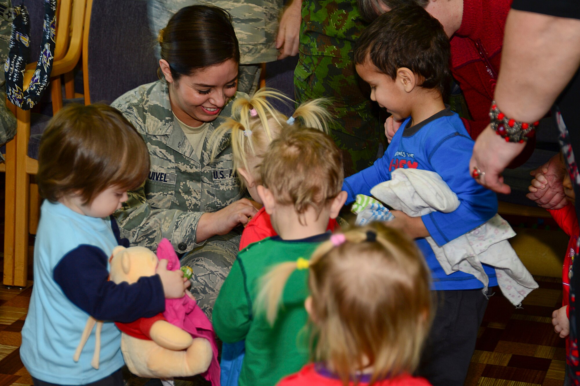 Senior Airman Yazmine Esquivel, 48th Air Expeditionary Group maintenance supply journeyman, passes out candy to children at Šiauliai City Baby’s Orphanage in Lithuania, Mar. 13, 2014. Airmen volunteered during the NATO Baltic Air Policing mission to give back to the host community and foster local partnerships. (U.S. Air Force by Airman 1st Class Dana J. Butler)