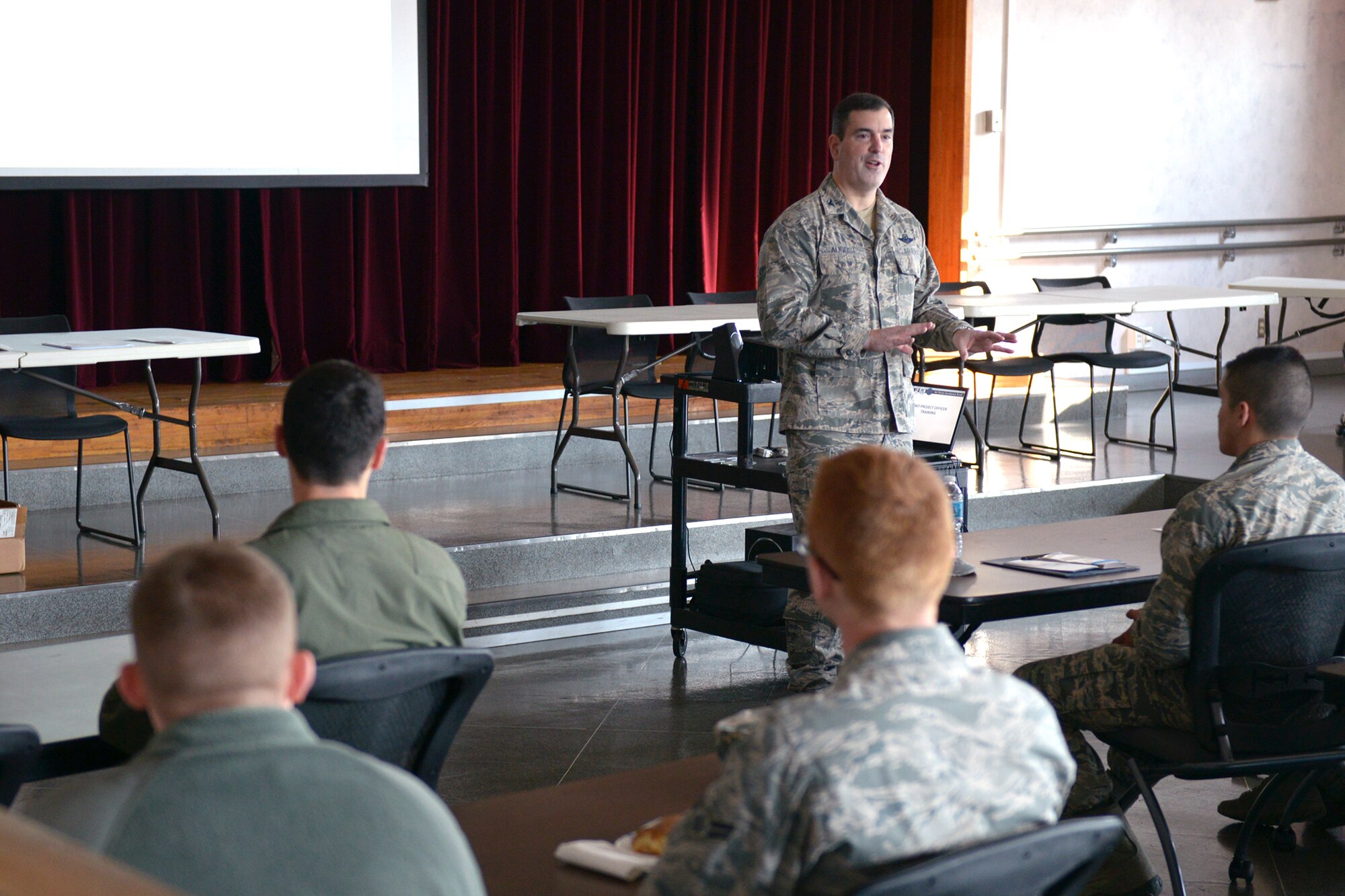 Col. Mark August, 374th Airlift Wing commander, briefs unit representatives on the Air Force Assistance Fund (AFAF) at Yokota Air Base, Japan, March 17, 2014. Donations to the AFAF are given to the Air Force Villages Inc., the Air Force Aid Society Inc., the General and Mrs. Curtis E. LeMay Foundation, and the Air Force Enlisted Village Inc. (U.S. Air Force photo by Airman 1st Class David Danford/Released)